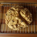 Rustic sourdough Irish soda bread cooling on a wire rack