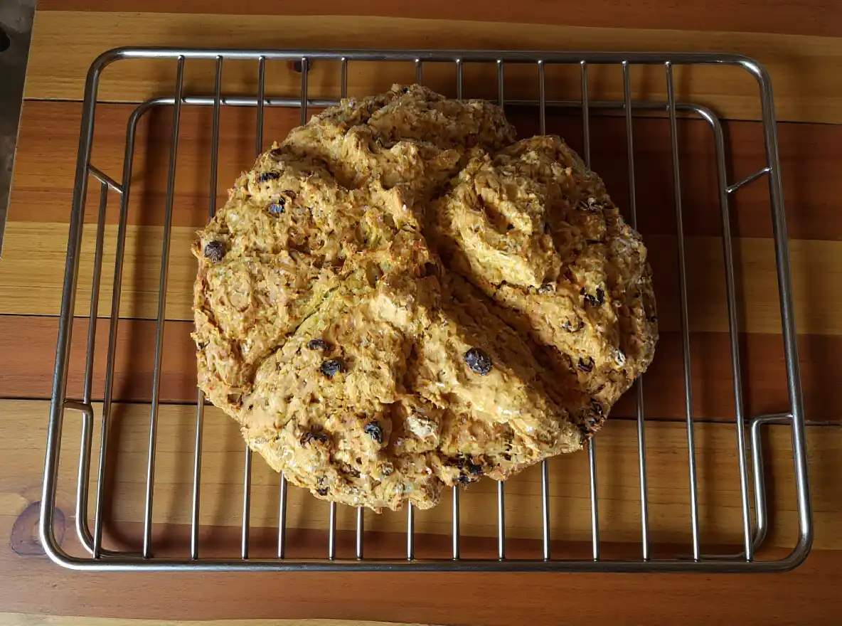 Rustic sourdough Irish soda bread cooling on a wire rack