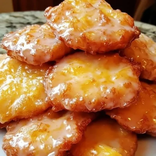 Freshly made peach fritters dusted with powdered sugar