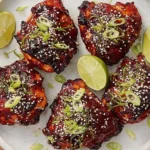Delicious air fryer spicy chicken thighs garnished with herbs
