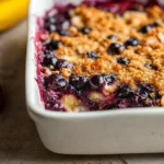 Baked oatmeal topped with fresh blueberries and sliced bananas