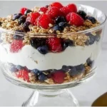 Delicious berry yogurt parfait trifle with fresh fruits and layers of yogurt