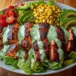 Grilled chicken salad with avocado and herb dressing on a plate