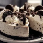 No-bake Oreo cheesecake with a chocolate cookie crust and whipped cream topping.