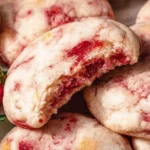 Delicious strawberry cheesecake cookies on a plate, topped with fresh strawberries