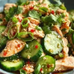 Thai Cucumber Salad with Chicken garnished with herbs and lime