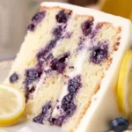 Delicious slice of zesty lemon blueberry cake with fresh blueberries and lemon zest