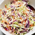 Fresh coleslaw made with cabbage and carrots in a creamy dressing
