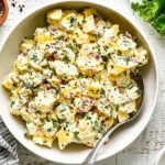 Delicious and creamy egg salad served in a bowl with fresh herbs